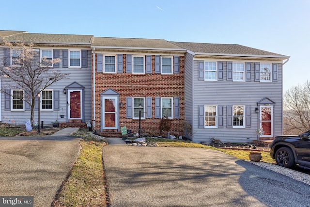 view of front facade featuring entry steps and brick siding