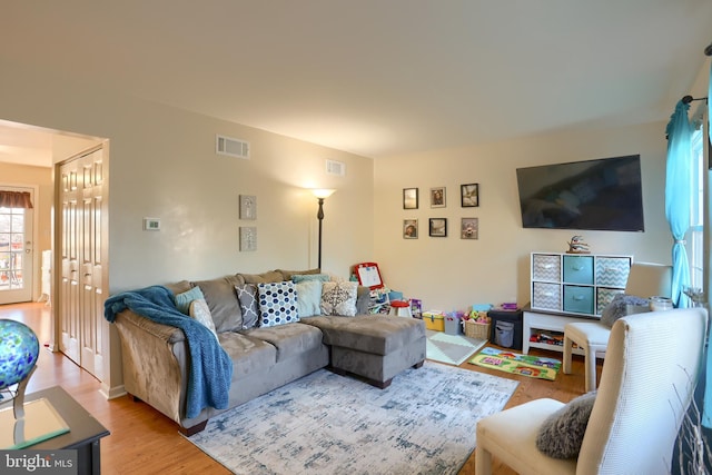 living room featuring visible vents and light wood-style floors