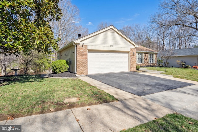 view of front of home with aphalt driveway, an attached garage, brick siding, and a front yard