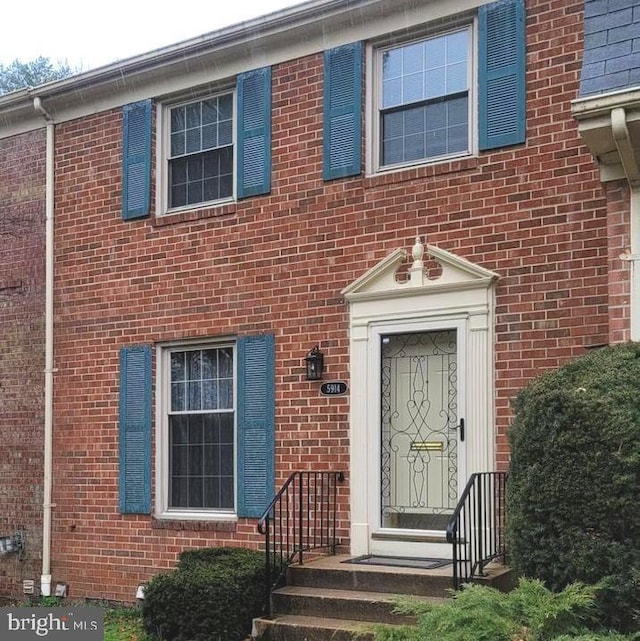 property entrance featuring brick siding