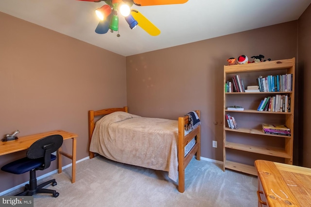 carpeted bedroom featuring baseboards and ceiling fan