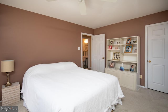 bedroom with light carpet, baseboards, and ceiling fan