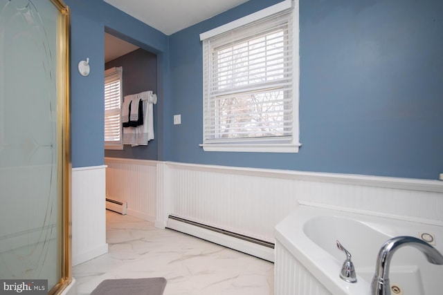 full bathroom with a wealth of natural light, a baseboard radiator, marble finish floor, and a wainscoted wall