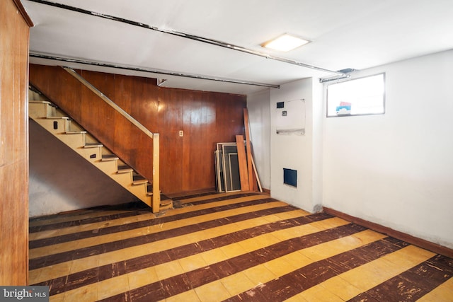 basement with stairs and wood finished floors