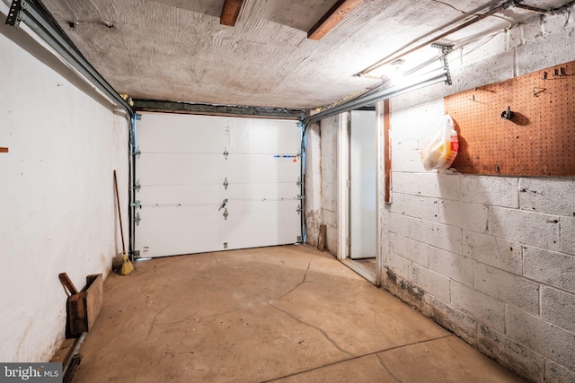 garage with concrete block wall