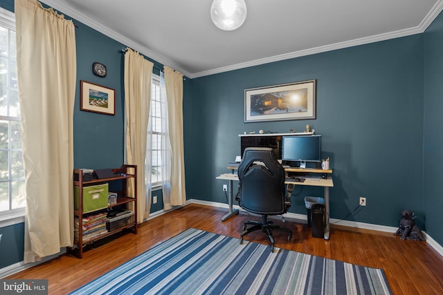 home office featuring crown molding, wood finished floors, and baseboards