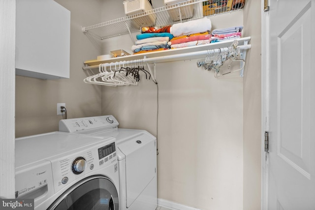 clothes washing area featuring laundry area and separate washer and dryer