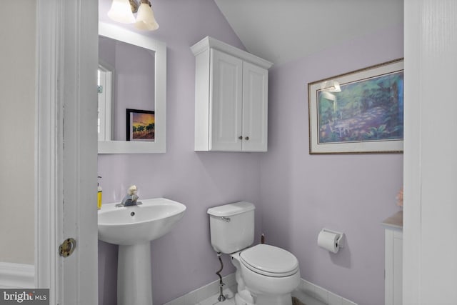 bathroom with toilet, baseboards, and a sink