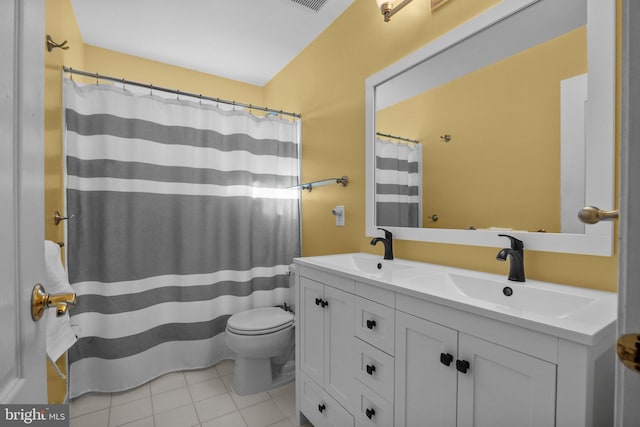 full bathroom featuring tile patterned flooring, double vanity, toilet, and a sink