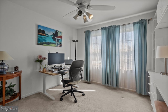 office space with baseboards, ceiling fan, and carpet floors