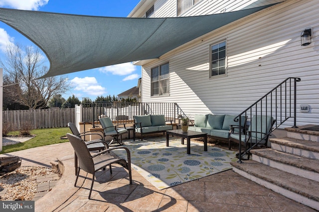 view of patio featuring outdoor lounge area and fence