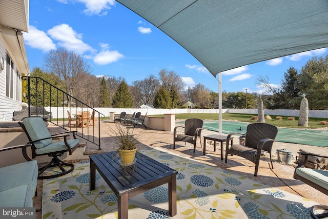 view of patio featuring a fenced in pool, outdoor dining area, and a fenced backyard