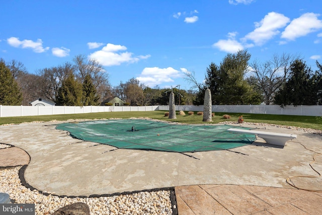 view of pool with a yard, a patio area, a fenced in pool, and a fenced backyard