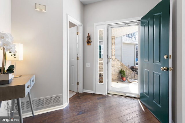 foyer with visible vents, baseboards, and hardwood / wood-style floors