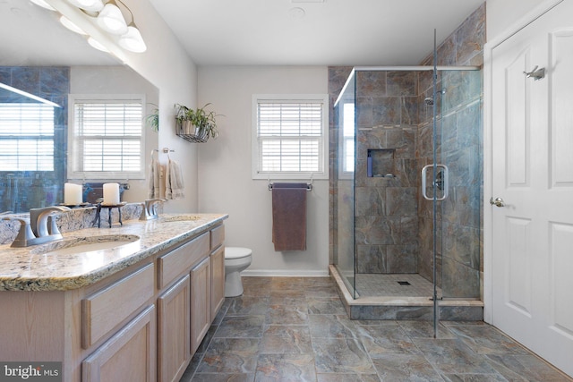 full bathroom featuring plenty of natural light, a stall shower, and a sink