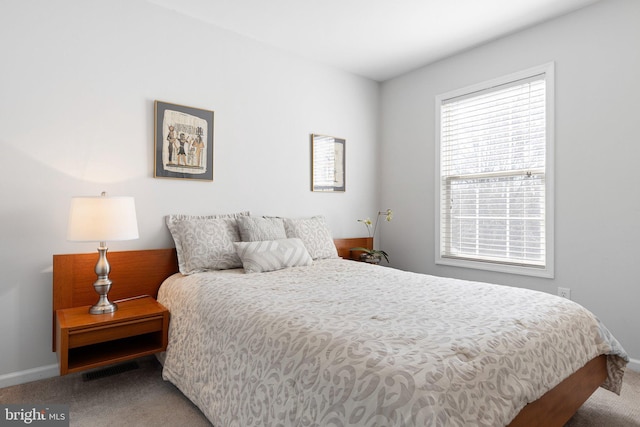 bedroom with carpet flooring and baseboards