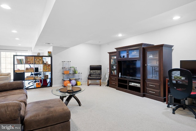 carpeted living area with recessed lighting and baseboards