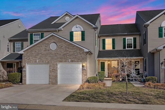 traditional-style home featuring brick siding, covered porch, driveway, and roof with shingles