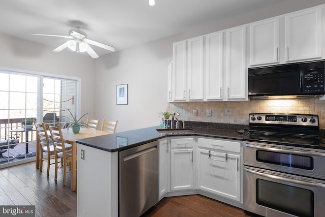 kitchen with a sink, tasteful backsplash, white cabinetry, and stainless steel appliances