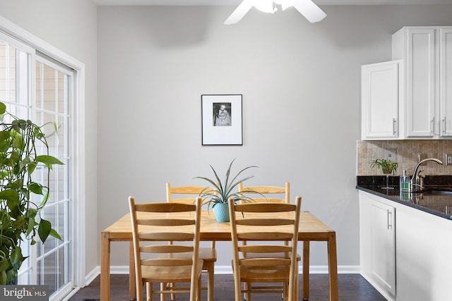 dining area with baseboards, dark wood-type flooring, a healthy amount of sunlight, and ceiling fan