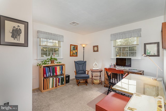 office space featuring carpet flooring, visible vents, and baseboards