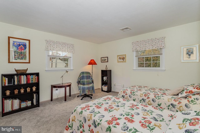 bedroom with visible vents, baseboards, and carpet