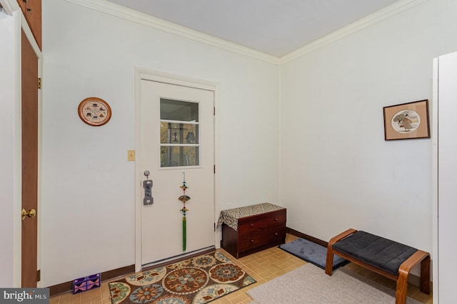 foyer entrance with baseboards and ornamental molding