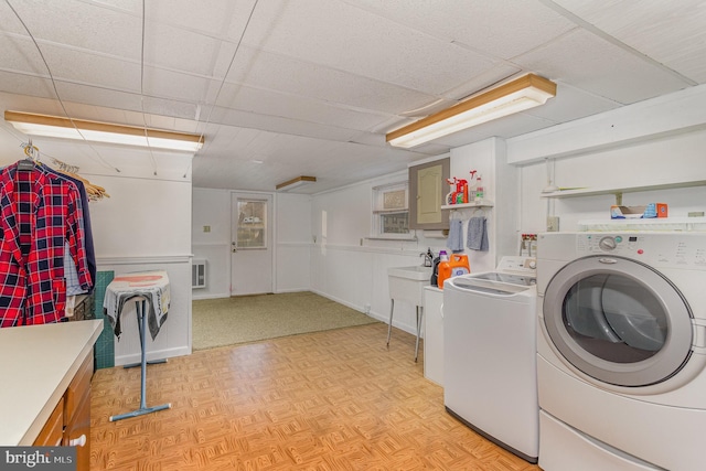 clothes washing area featuring visible vents, baseboards, washing machine and dryer, light floors, and laundry area