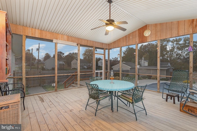 sunroom / solarium with lofted ceiling and ceiling fan