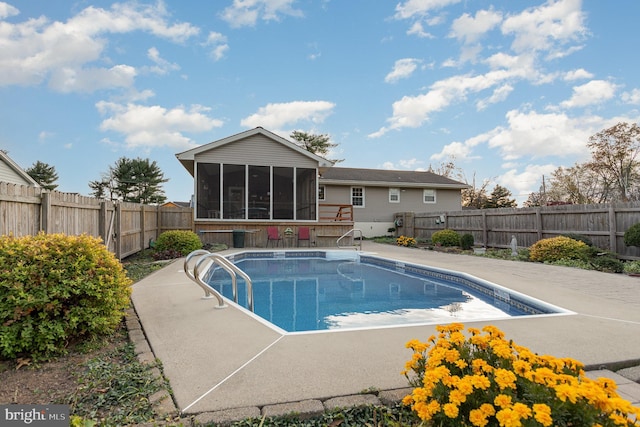 view of swimming pool with a fenced backyard, a fenced in pool, and a sunroom