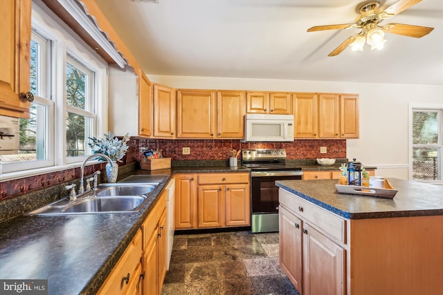 kitchen featuring white appliances, ceiling fan, a sink, dark countertops, and tasteful backsplash