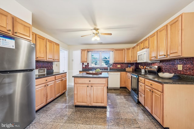 kitchen featuring decorative backsplash, dark countertops, granite finish floor, and stainless steel appliances