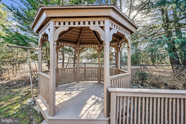 wooden deck featuring a gazebo and fence