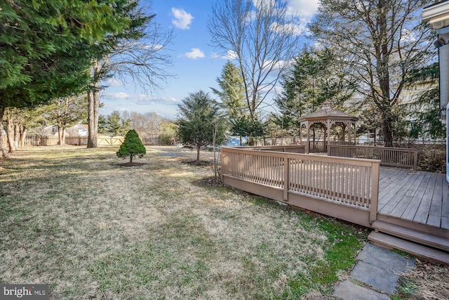 view of yard featuring a gazebo, a deck, and fence