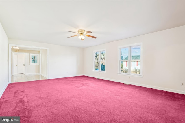 unfurnished room with baseboards, a ceiling fan, and carpet floors