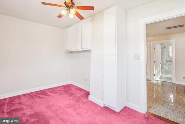 interior space with visible vents, baseboards, ceiling fan, and granite finish floor