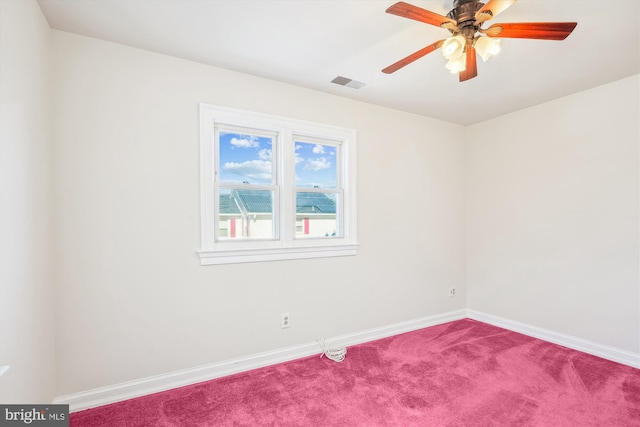 empty room with carpet, baseboards, visible vents, and a ceiling fan