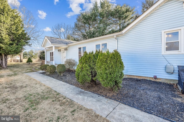 view of side of home featuring a yard