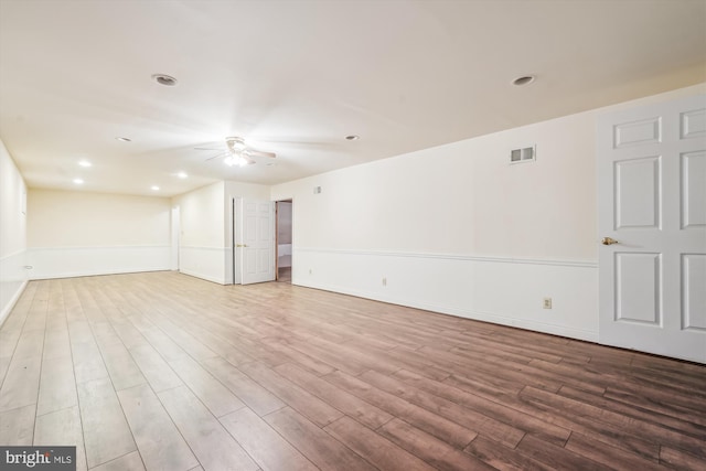 spare room with visible vents, a ceiling fan, wood finished floors, recessed lighting, and baseboards