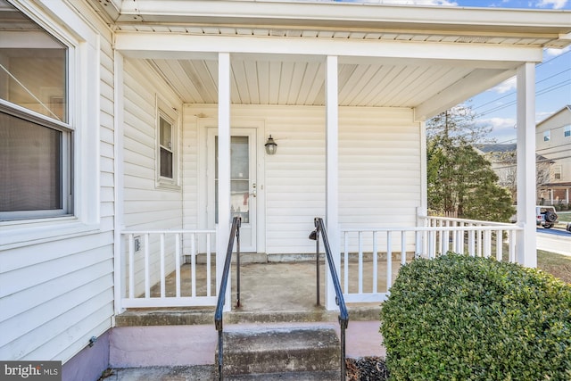 view of exterior entry with covered porch