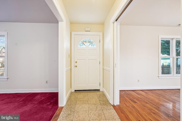 foyer entrance featuring baseboards