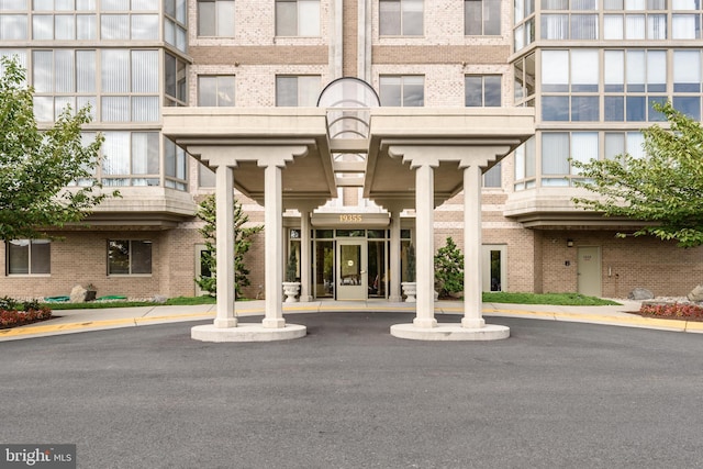 view of exterior entry with brick siding