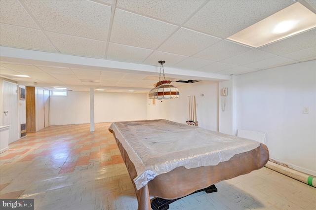 playroom with a paneled ceiling