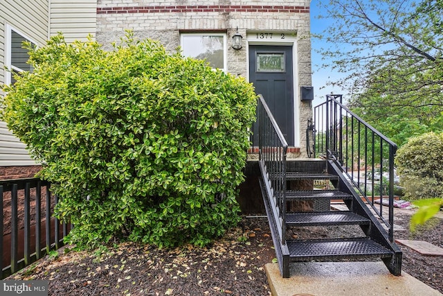 property entrance featuring brick siding