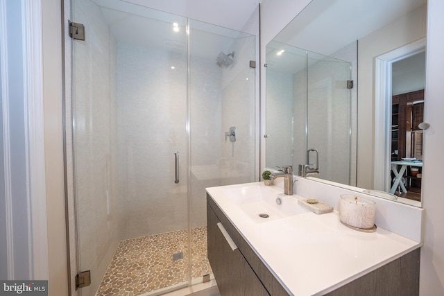 bathroom featuring a shower stall and vanity