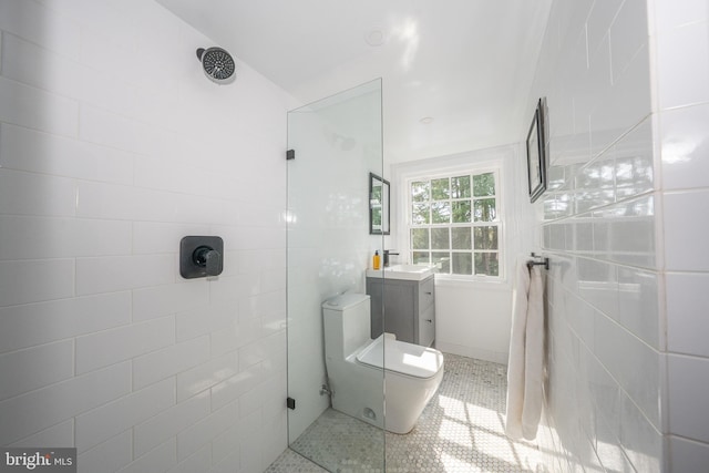 full bathroom with vanity, toilet, tile patterned flooring, and a tile shower