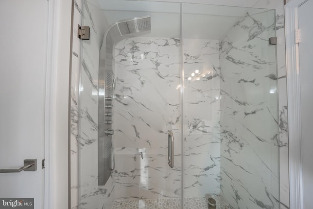 full bathroom with a marble finish shower