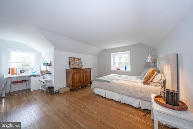 bedroom featuring vaulted ceiling and hardwood / wood-style flooring