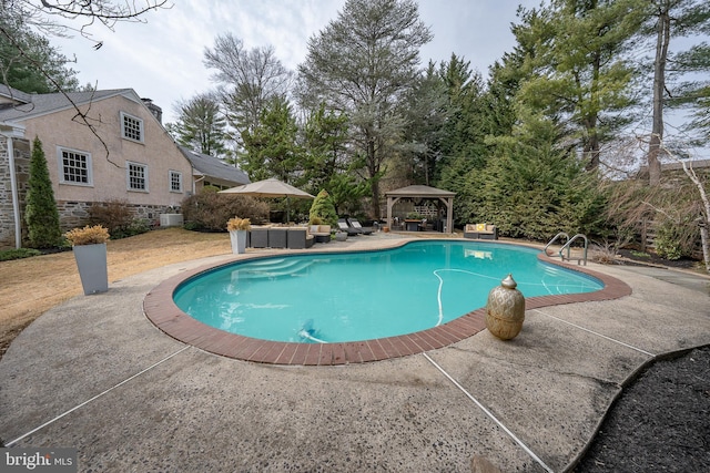 pool with a gazebo and a patio