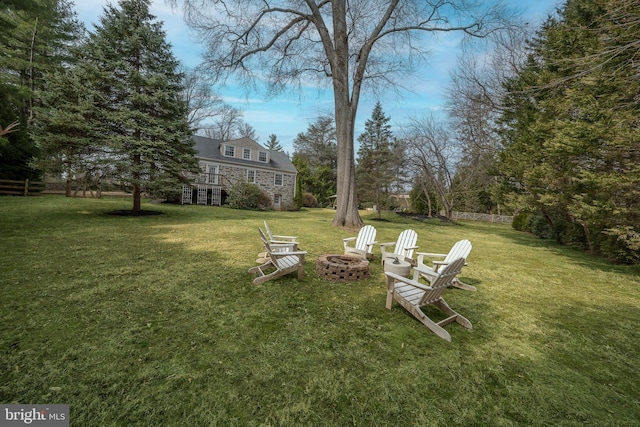 view of yard featuring a fire pit and fence